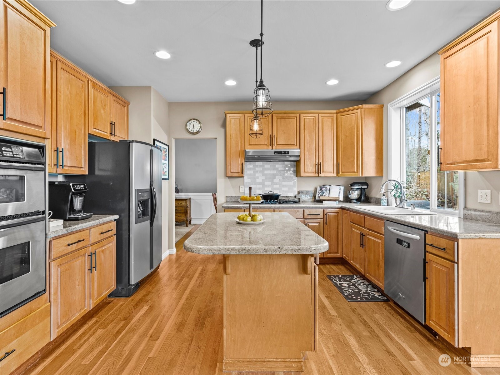 9506 Northeast 191st Street Bothell, WA 98011 - Photo 18 of 40 a large kitchen with granite countertop a large counter top stainless steel appliances and cabinets