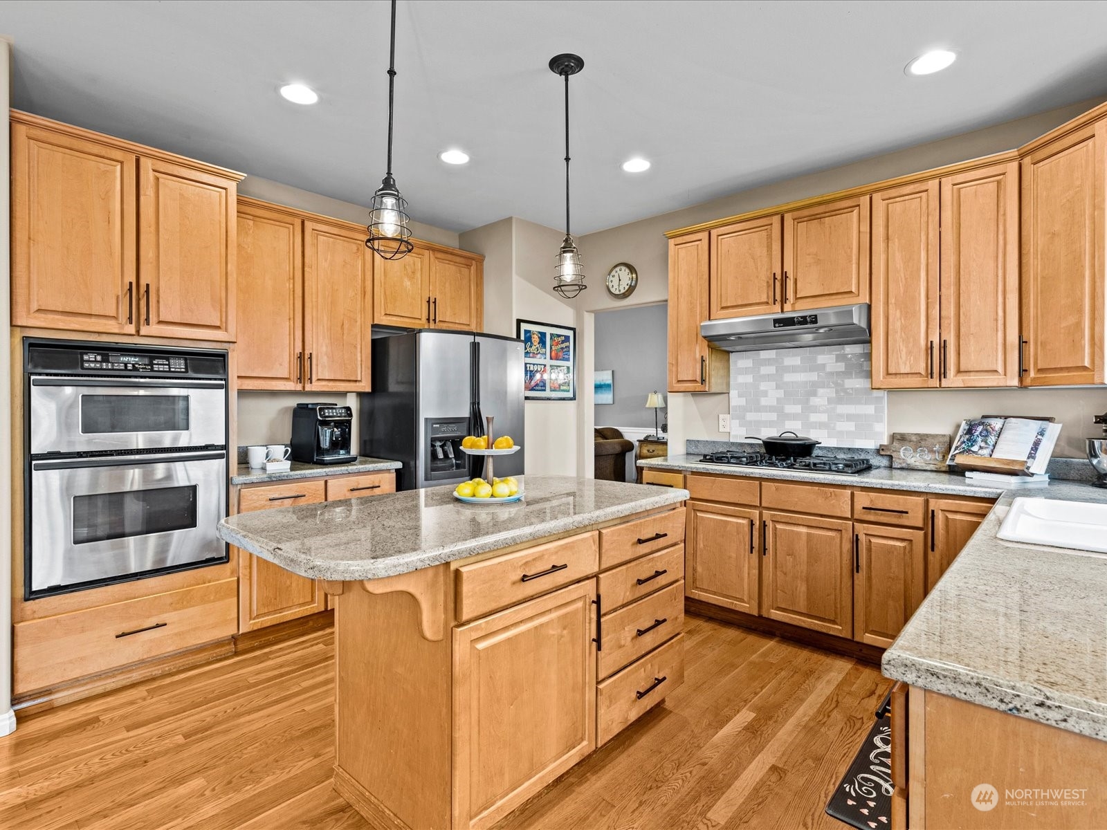 9506 Northeast 191st Street Bothell, WA 98011 - Photo 2 of 40 a kitchen with stainless steel appliances granite countertop a stove top oven a sink dishwasher a refrigerator and cabinets with wooden floor