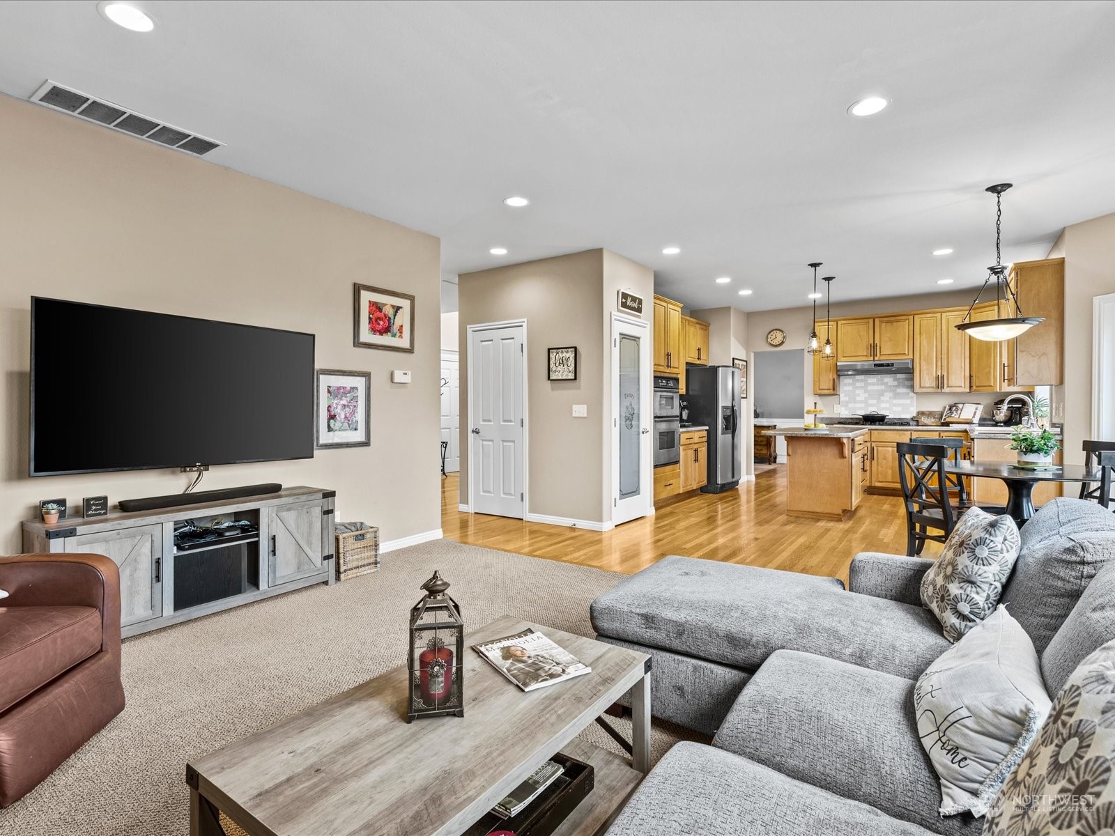 9506 Northeast 191st Street Bothell, WA 98011 - Photo 23 of 40 a living room with furniture and a flat screen tv