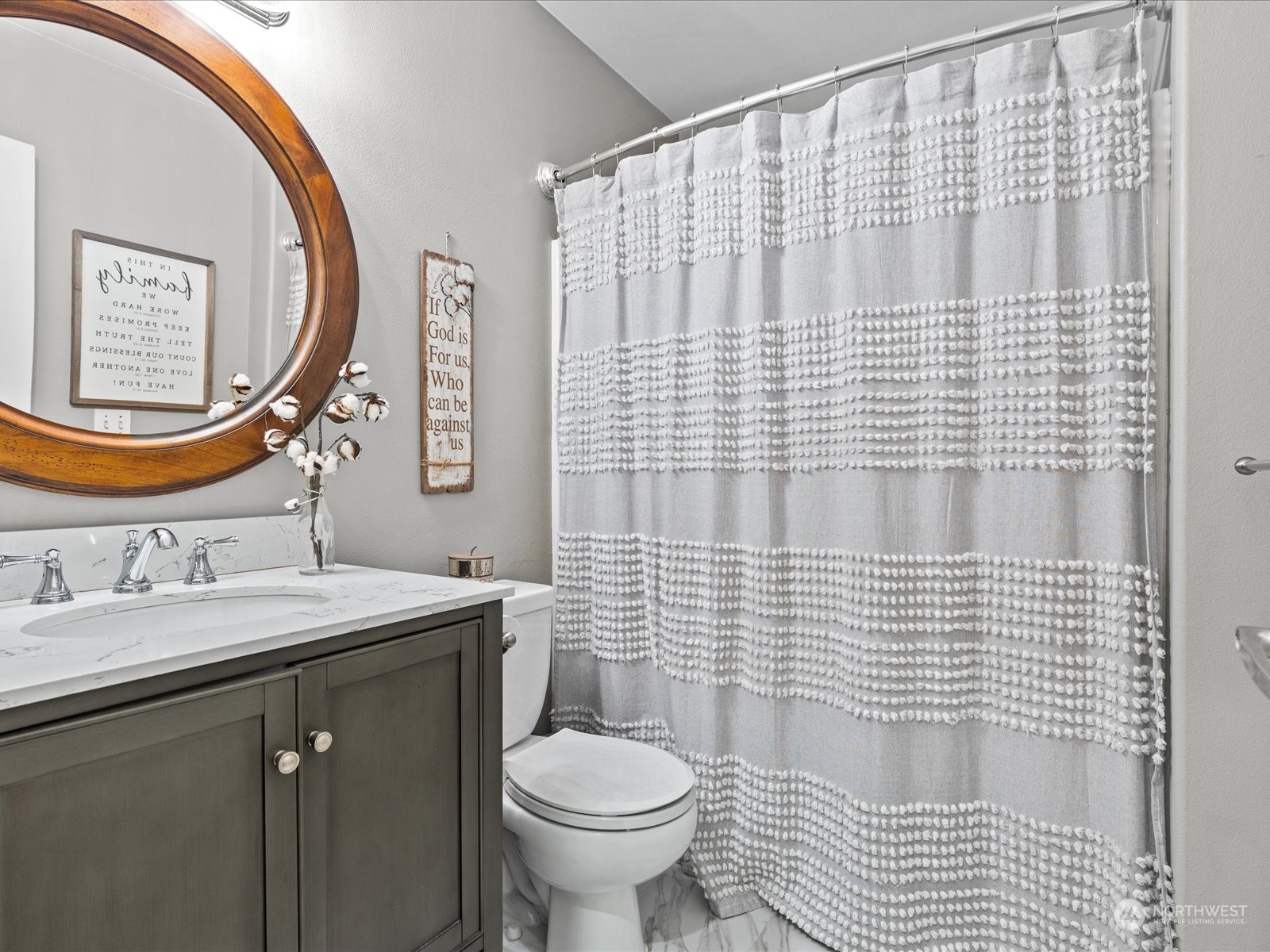 9506 Northeast 191st Street Bothell, WA 98011 - Photo 25 of 40 a bathroom with a sink a toilet and a mirror