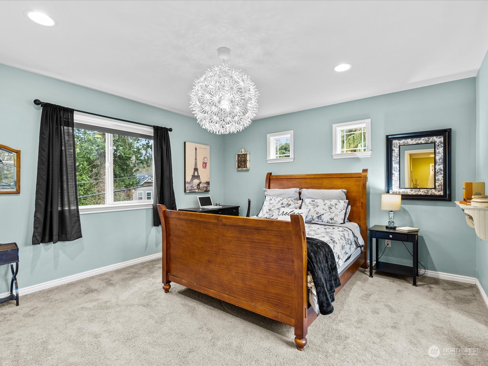 9506 Northeast 191st Street Bothell, WA 98011 - Photo 32 of 40 a bedroom with a bed and a chandelier