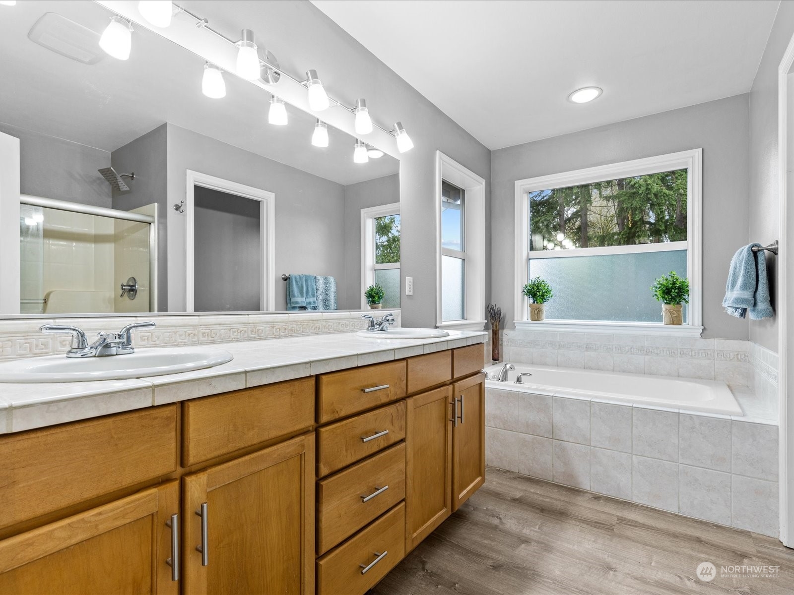 9506 Northeast 191st Street Bothell, WA 98011 - Photo 4 of 40 a bathroom with a granite countertop sink mirror and a bathtub