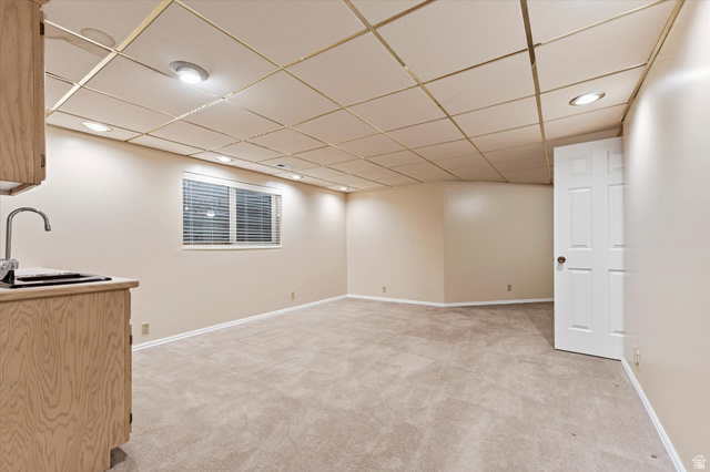 888 East 6895 South Midvale, UT 84047 - Photo 31 of 54 Spacious lower-level living area with recessed lighting and neutral tones, ideal for a media room, game space, or additional lounge area.
