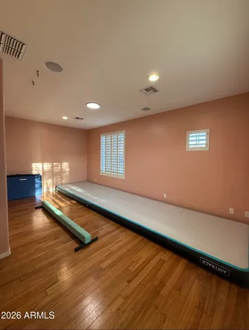 a bedroom with a bed and a large window