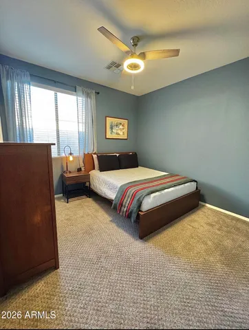 a view of a patio with table and chairs potted plants with wooden floor and fence