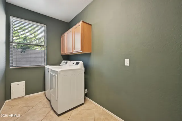 a view of a house with backyard and a tree