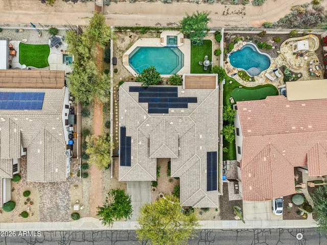 an aerial view of residential houses with outdoor space