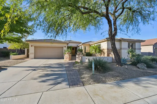 an aerial view of a house with a mountain