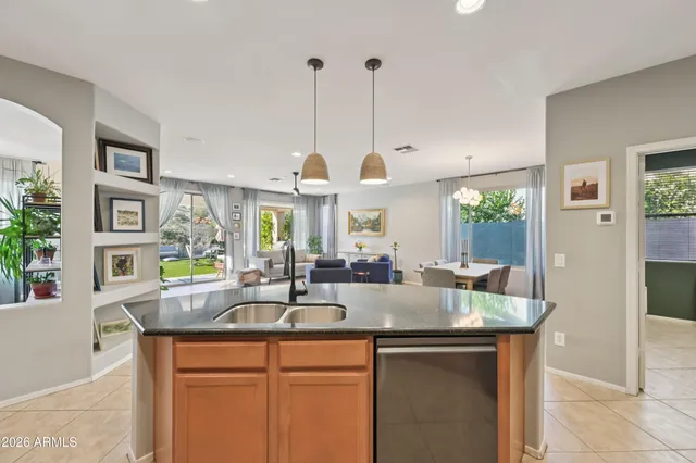 a living room with furniture a fireplace and a large window