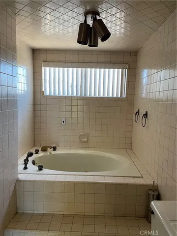 a bathroom with a bathtub and window