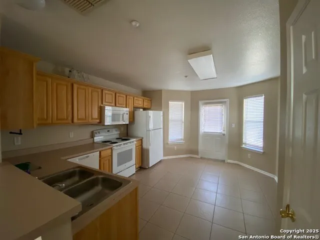 a kitchen that has a sink and a stove top oven