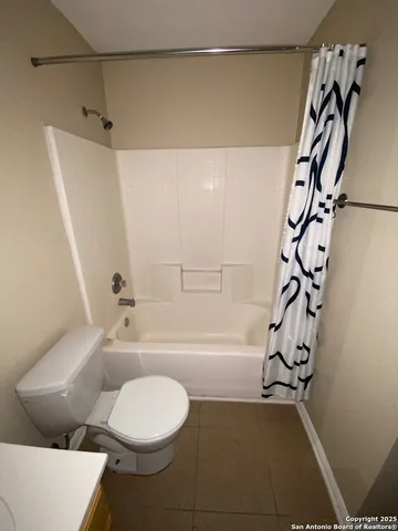 a bathroom with a toilet and a bathtub