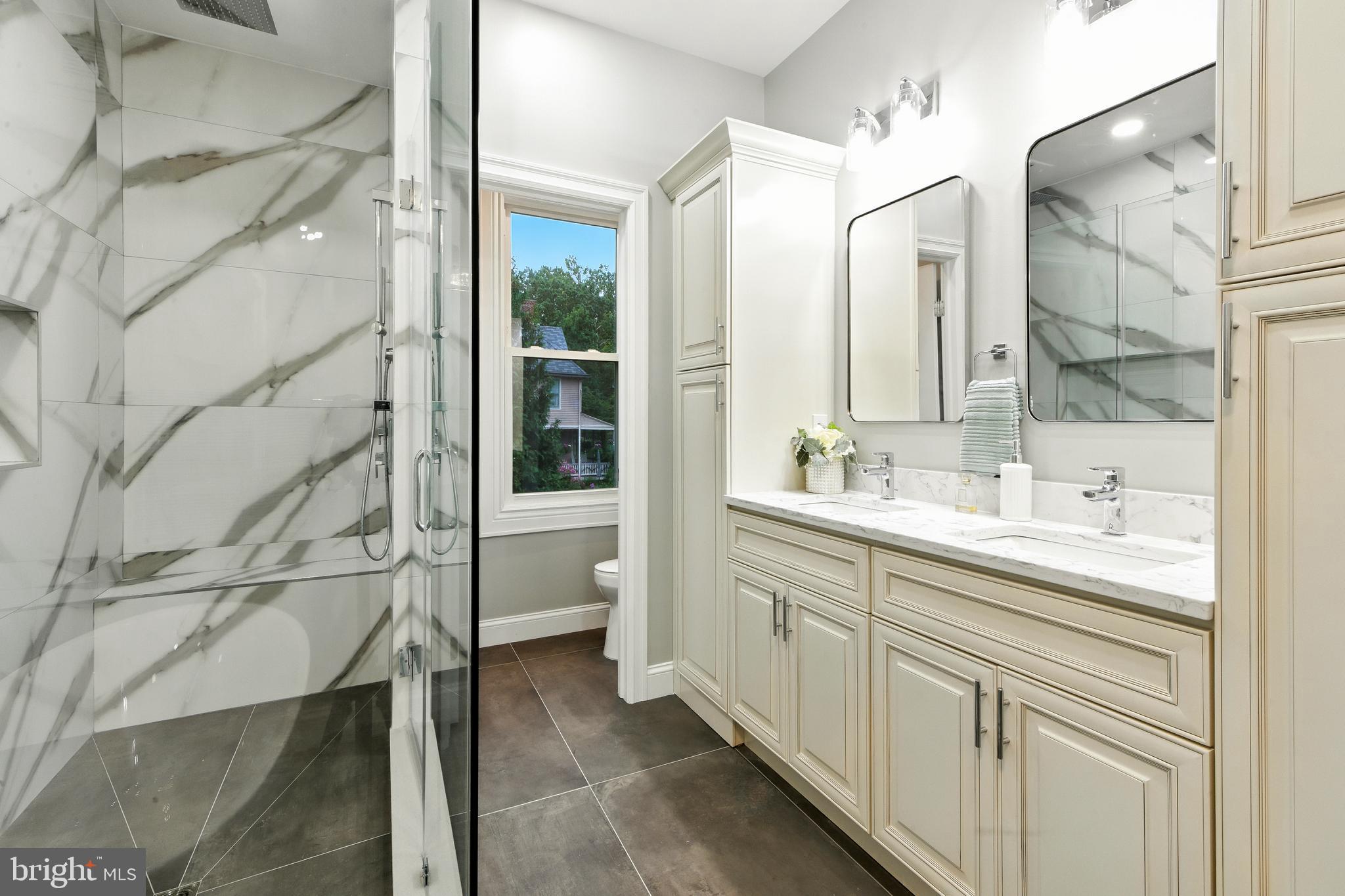 713 Main Street Riverton, NJ 08077 - Photo 16 of 36 a spacious bathroom with a shower sink and mirror