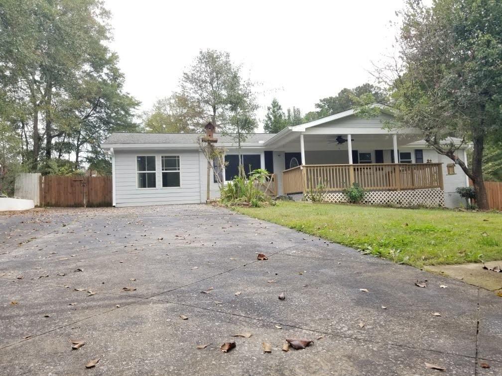 3492 Ridgecrest Drive Powder Springs, GA 30127 - Photo 1 of 1 a front view of a house with a yard and potted plants