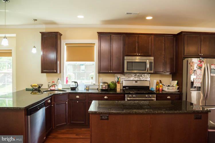 a kitchen with a sink stove and microwave