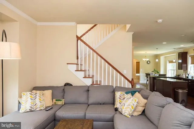 a living room with furniture and stairs