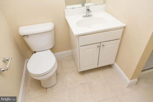 a white toilet sitting next to a white sink
