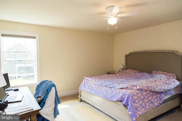 a bedroom with a bed and a chair