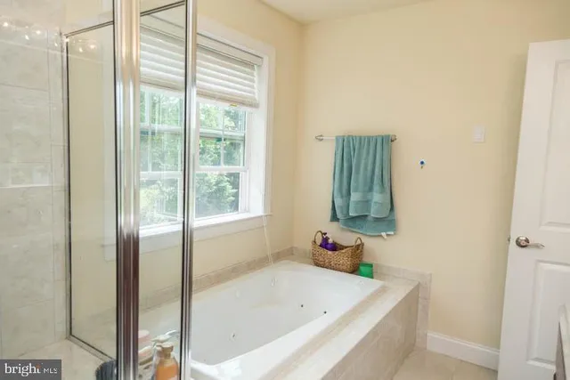 a bathroom with a bathtub and shower
