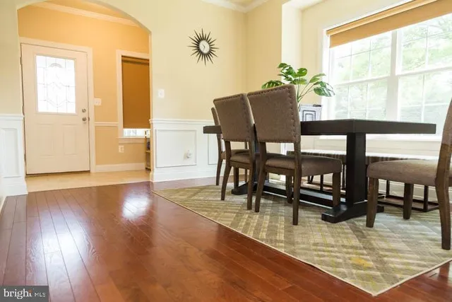 a dining room with furniture and wooden floor