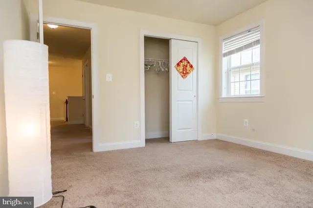 an empty room with windows and closet