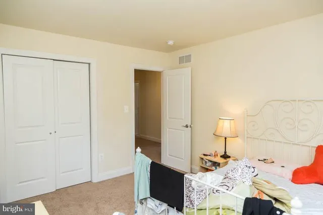 a bedroom with a bed and a lamp