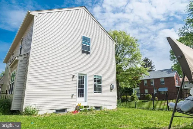 a view of house with a backyard
