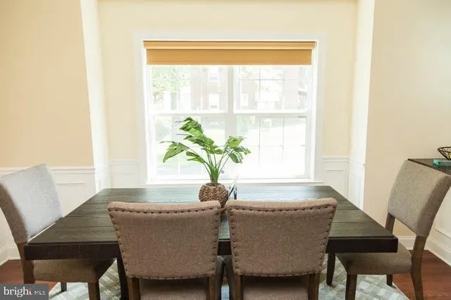 a dining room with furniture and window