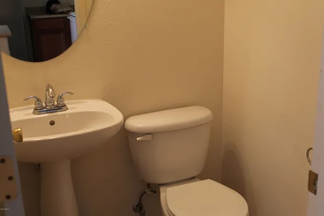a white toilet sitting next to a bathroom sink