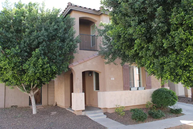 front view of a house with a tree