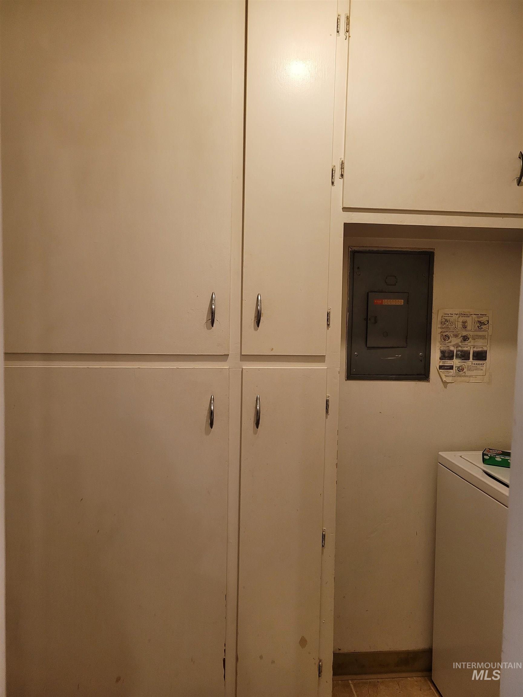 401 South 4th Street Rupert, ID 83350 - Photo 15 of 19 Washroom with washer / dryer, electric panel, cabinet space, and tile patterned floors