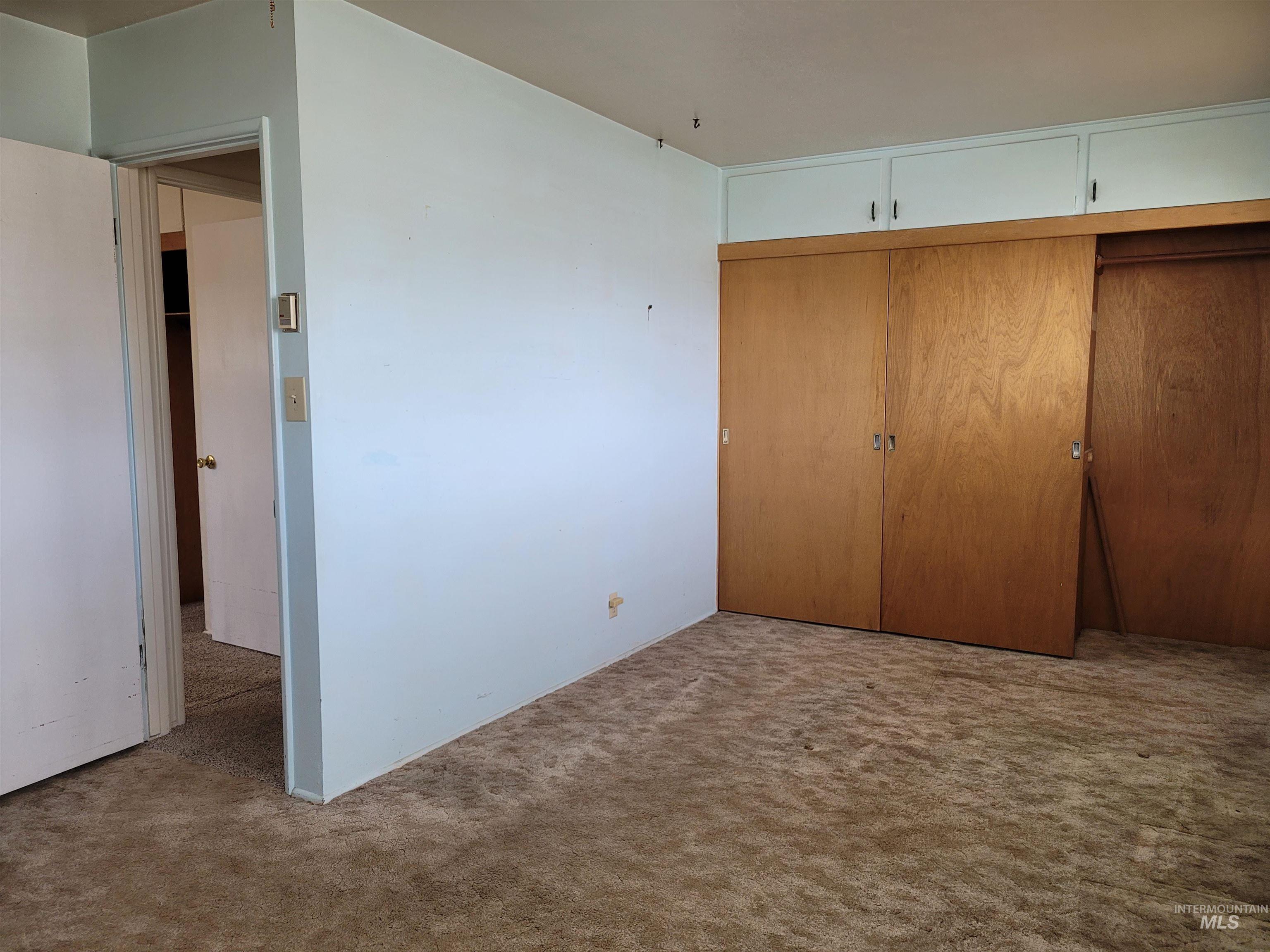 401 South 4th Street Rupert, ID 83350 - Photo 17 of 19 Unfurnished bedroom featuring a closet and carpet flooring