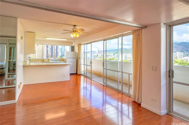 a view of a kitchen with wooden floor and a window
