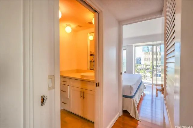 a view of a hallway with wooden floor and a livingroom view