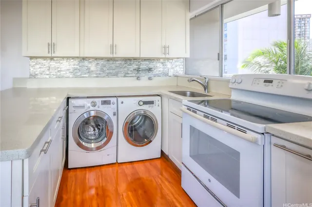 a utility room with sink dryer and washer