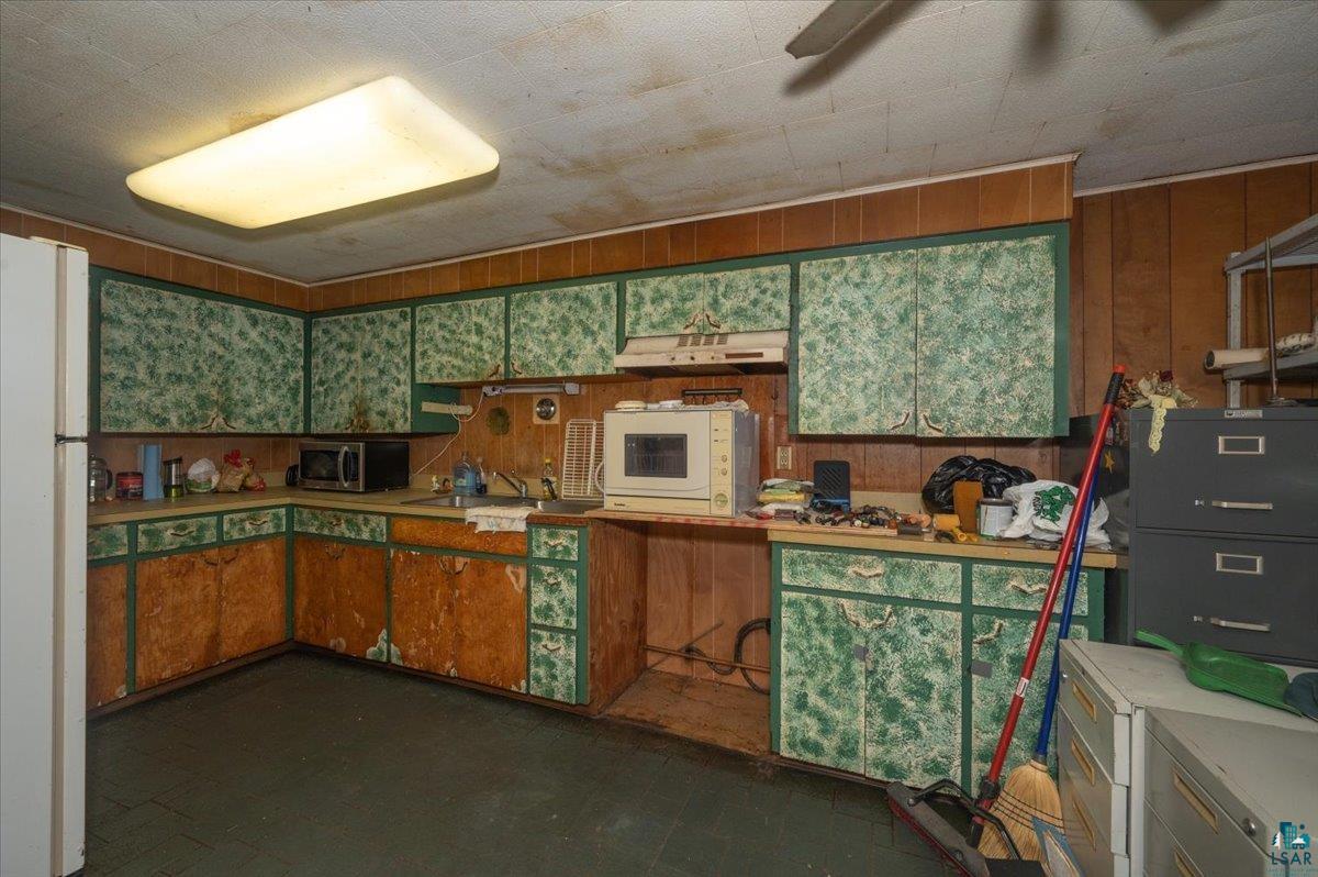 1717 Winter Street Superior, WI 54880 - Photo 11 of 15 Kitchen featuring wood walls and white appliances on the upper level