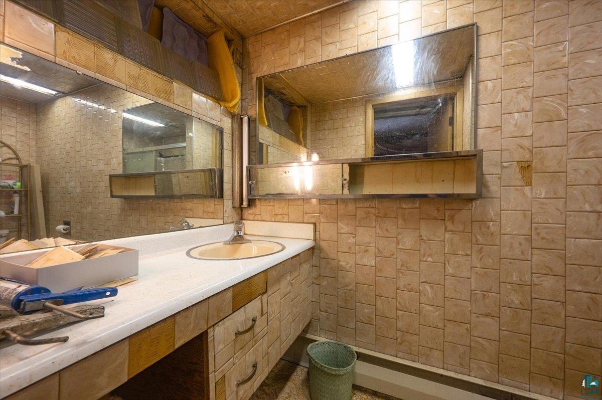 1717 Winter Street Superior, WI 54880 - Photo 14 of 15 Bathroom with tile walls and large vanity in upper level