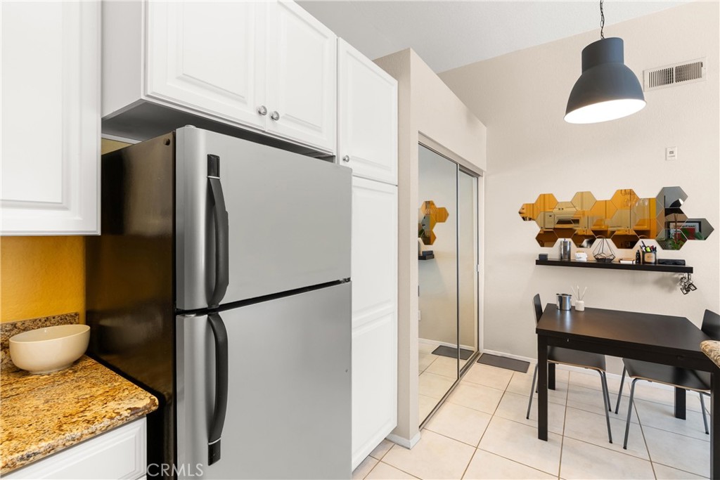 27 Castano Rancho Santa Margarita, CA 92688 - Photo 11 of 24 a kitchen with stainless steel appliances granite countertop a refrigerator and a stove