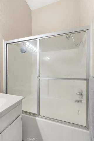 a bathroom with a glass shower door