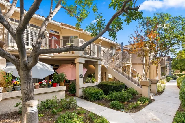 a front view of a building with a garden