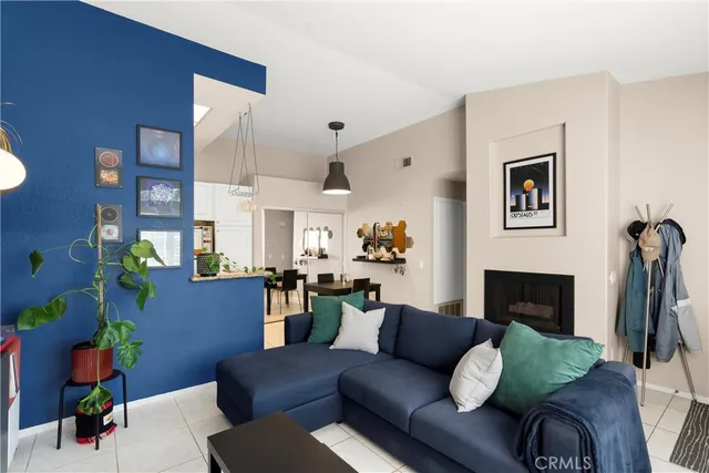 a living room with furniture fireplace and a window