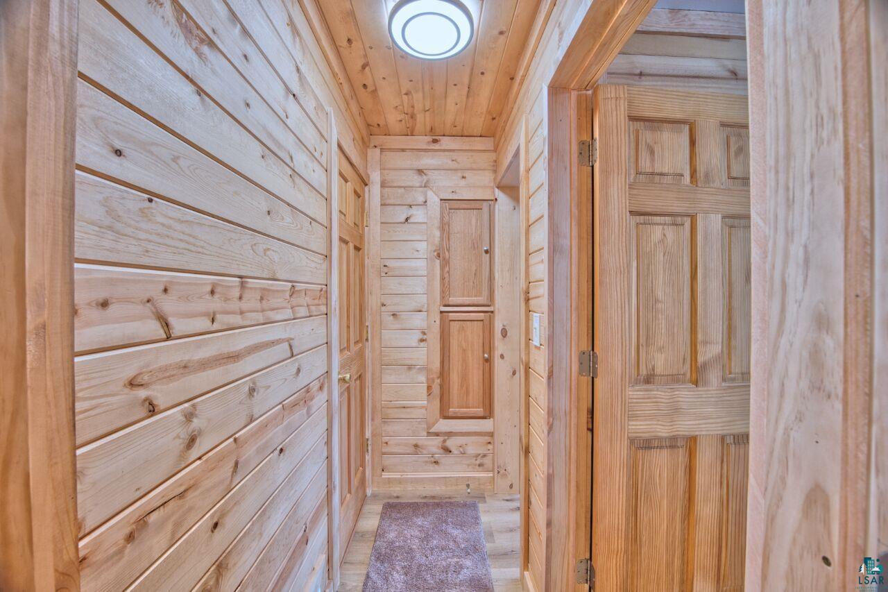 802 3rd Street Northwest Chisholm, MN 55719 - Photo 12 of 51 Hall with wood walls and wooden ceiling