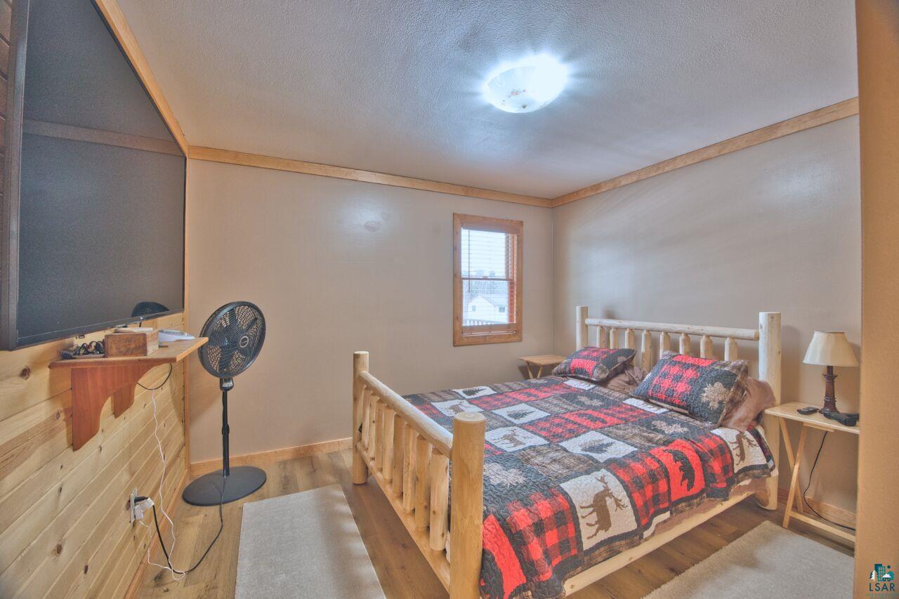 802 3rd Street Northwest Chisholm, MN 55719 - Photo 15 of 51 Bedroom with wood finished floors and a textured ceiling