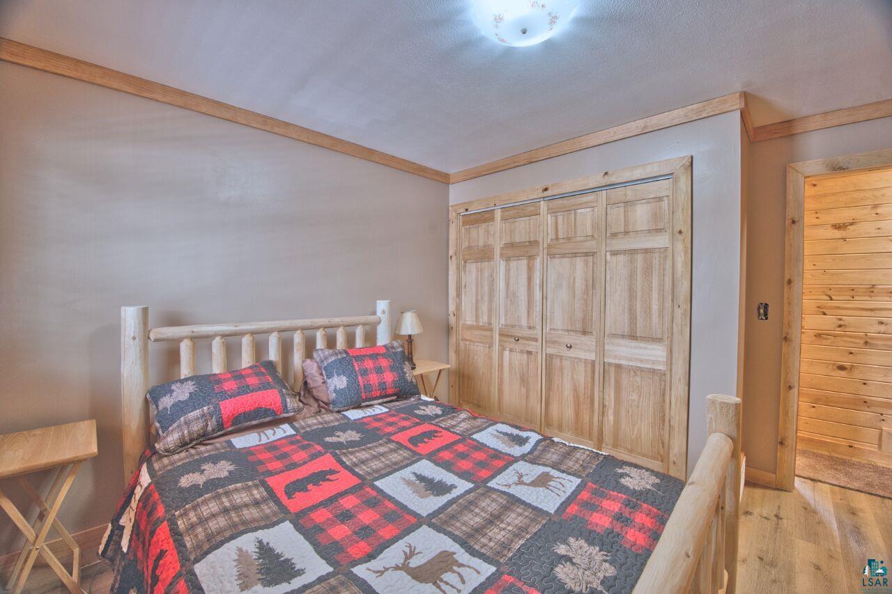 802 3rd Street Northwest Chisholm, MN 55719 - Photo 17 of 51 Bedroom featuring a closet and wood finished floors