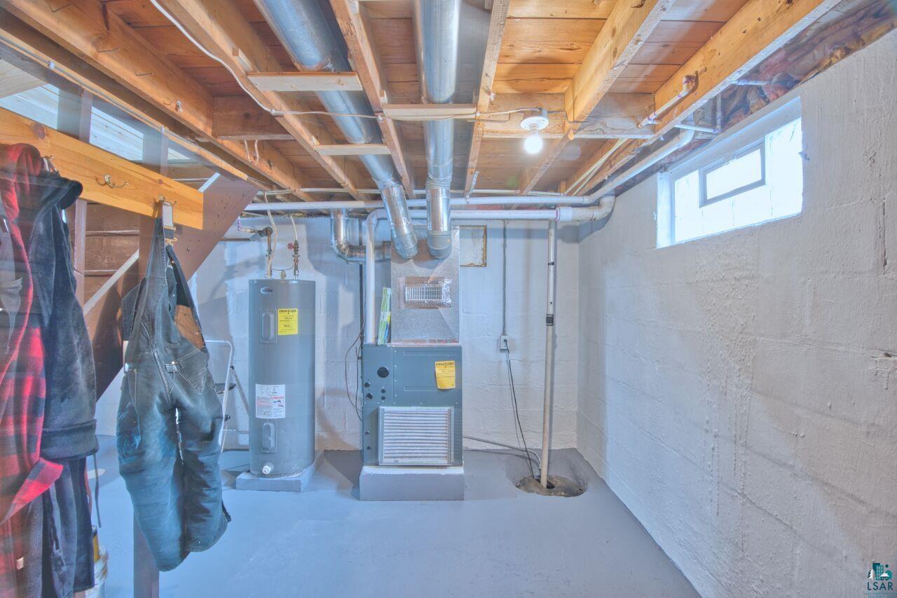 802 3rd Street Northwest Chisholm, MN 55719 - Photo 26 of 51 Below grade area with electric water heater and heating unit
