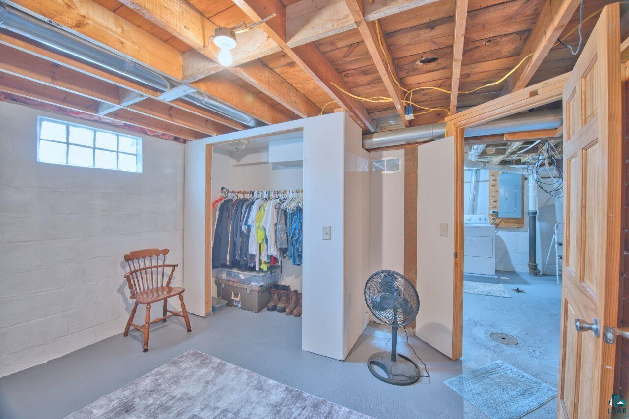 802 3rd Street Northwest Chisholm, MN 55719 - Photo 28 of 51 Basement featuring electric panel and washer / dryer