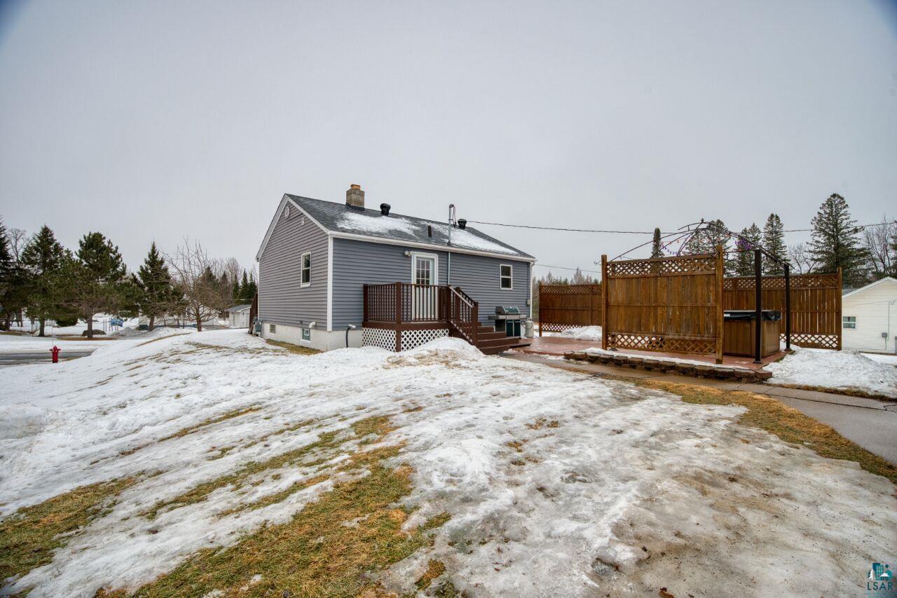 802 3rd Street Northwest Chisholm, MN 55719 - Photo 29 of 51 Snow covered property with a chimney and a deck