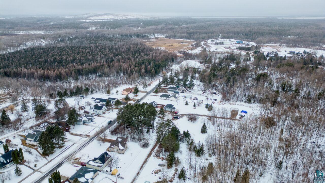 802 3rd Street Northwest Chisholm, MN 55719 - Photo 43 of 51 Snowy aerial view featuring a view of trees