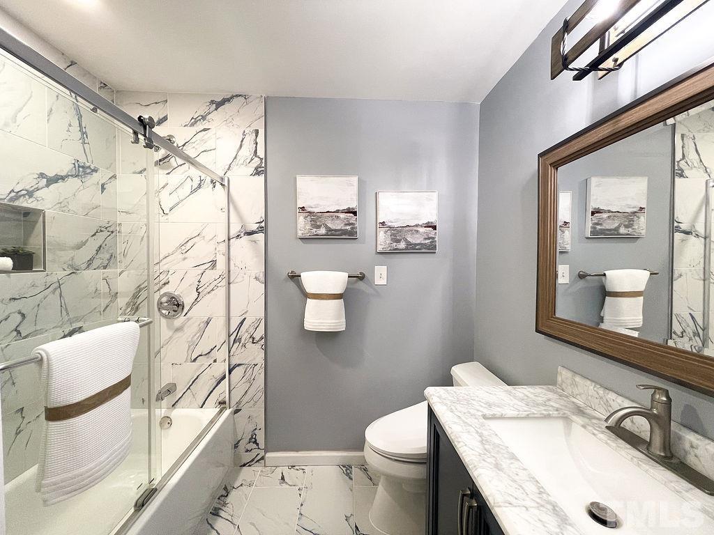 6700 Laurdane Road Raleigh, NC 27613 - Photo 14 of 25 a bathroom with a sink toilet and shower