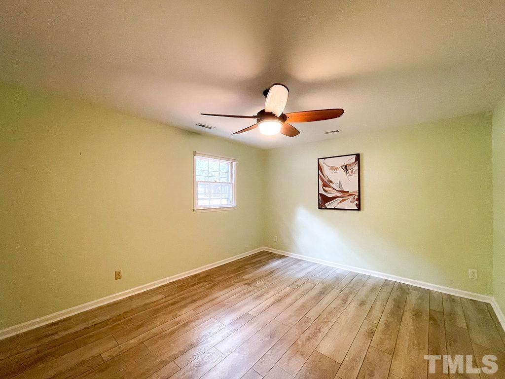 6700 Laurdane Road Raleigh, NC 27613 - Photo 15 of 25 a view of empty room with wooden floor